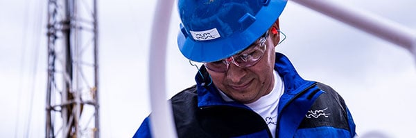 Oil refinery worker looking down